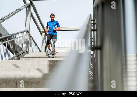 Man running down stairs Stock Photo