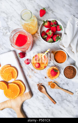 Strawberry and orange smoothie with curcuma and cinnamon on marble Stock Photo