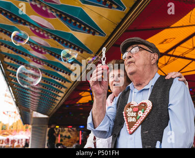 Senior couple having fun together on fair Stock Photo