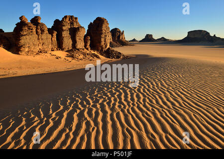 Africa, Algeria, Sahara, Tassili N'Ajjer National Park, Tadrart, Rock towers and sand dunes in Tiou Tatarene Stock Photo