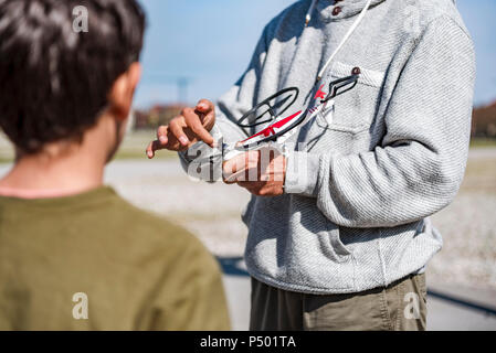 Father and son playing with flying drone, family Stock Photo - Alamy