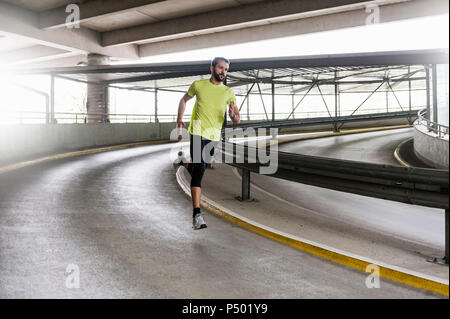 Man running in parking garage in a curve Stock Photo