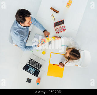 Two business people at meeting table in office, top view Stock Photo