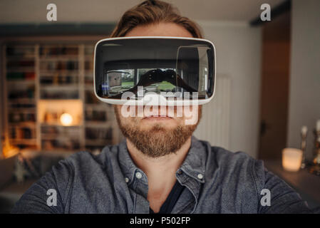 Mature man taking selfie of himself, wearing VR glasses, looking cool Stock Photo