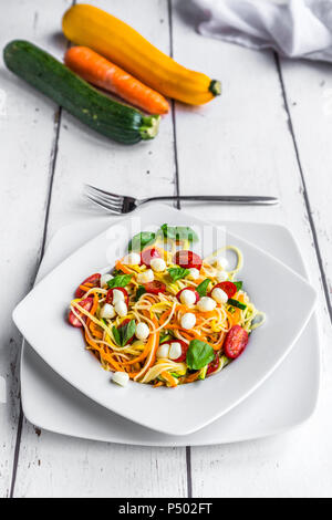 Zoodles with spaghettis, tomatoes and mini mozzarella cheese balls Stock Photo