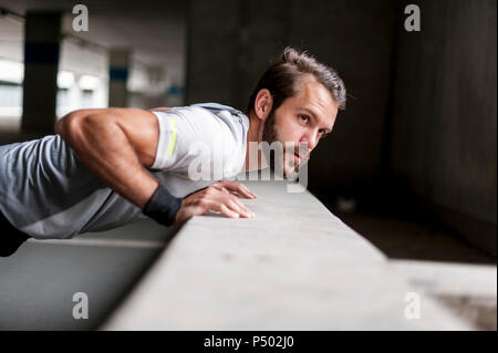 Portrait of man doing push-ups Stock Photo