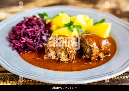 Beef roulade with potato and red cabbage on plate Stock Photo