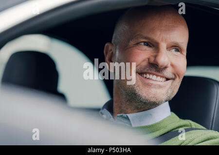 Portrait of smiling mature man in car Stock Photo