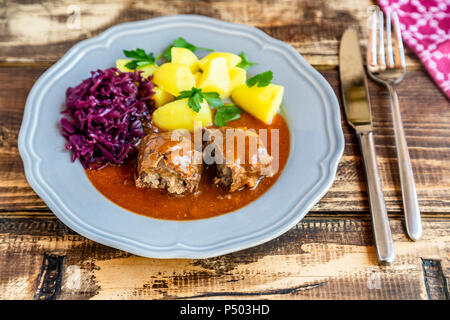 Beef roulade with potato and red cabbage on plate Stock Photo