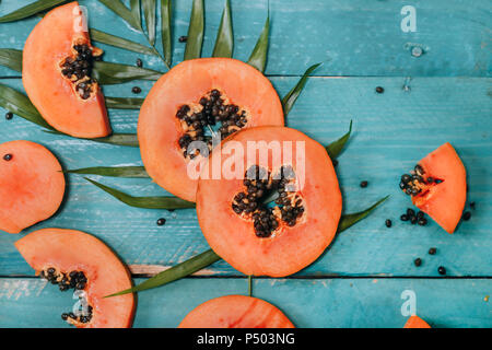 Sliced papaya on blue wood Stock Photo