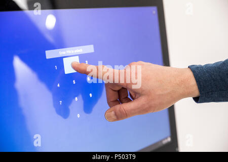 Businessman entering PIN code on touch screen Stock Photo