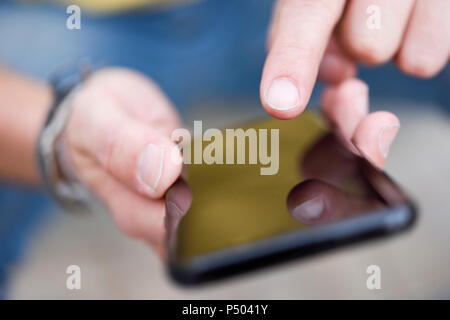 Young man touching on smartphone display Stock Photo