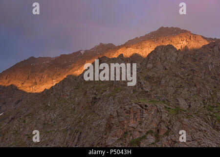 Beautiful alpenglow in the Tian Shan Mountains, Karakol, Kyrgyzstan Stock Photo