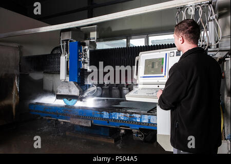 Stonemason working with CNC machine in his workshop Stock Photo