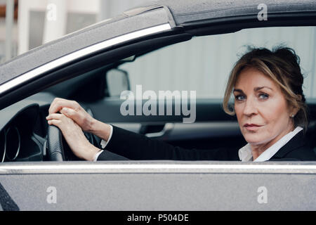 Portrait of confident senior businesswoman in car Stock Photo
