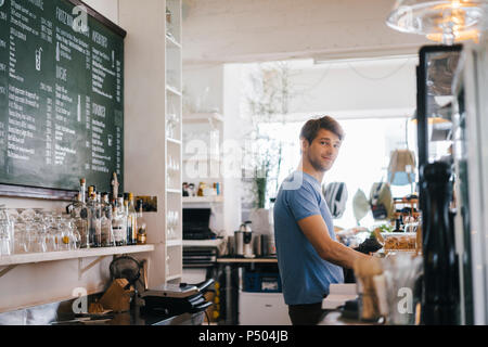 Portrait of smiling man in a cafe Stock Photo