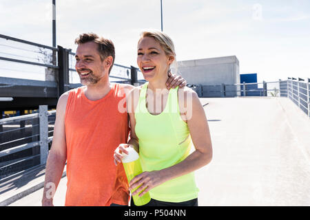 Fit couple jogging in the city, having fun, taking a break Stock Photo