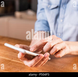 Woman's hands using smartphone, close-up Stock Photo