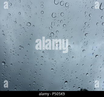 Rain drops on the window on a cloudy day. Stock Photo
