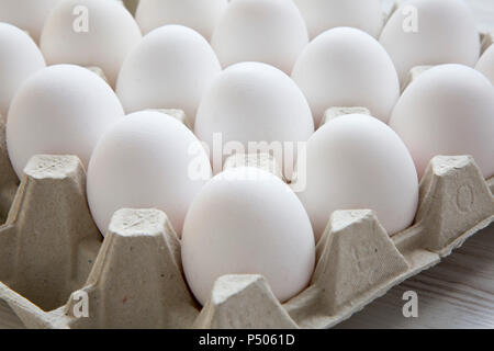 Chicken eggs in egg box, close-up. Side view. Stock Photo