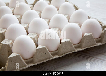 Chicken eggs in carton egg box, closeup. Side view. Stock Photo