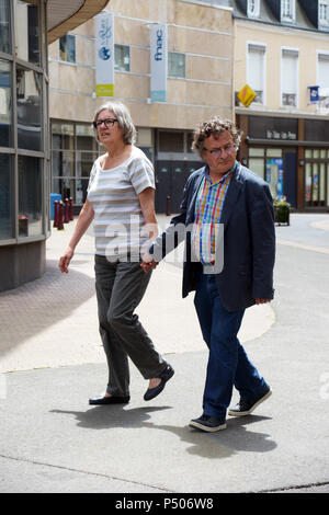 Happy couple walking through the quiet sunday streets Le Mans, France Stock Photo