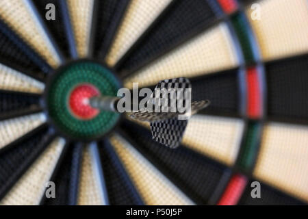 a dart hits target in the centre of dartboard Stock Photo