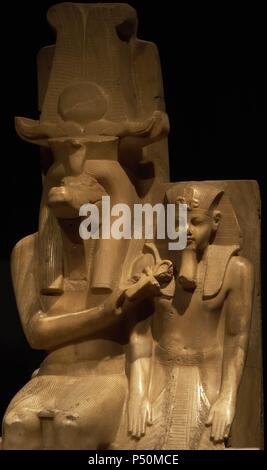 Statue of Amenhotep III (Neb-Maat-Ra) and Sobek c.1390-1352 BC. Carved from Calcite (Egyptian Alabaster). Found in the Sobek temple at Dahamsha. Sobek is seated in a human form with the crocodile head and  his right hand holds the Ankh giving life to the youthful Amenhotep III.  The King is wearing the Nemes headdress, with the uraeus and royal beard. 18th Dynasty. New Kingdom. Luxor Museum. Egypt. Stock Photo