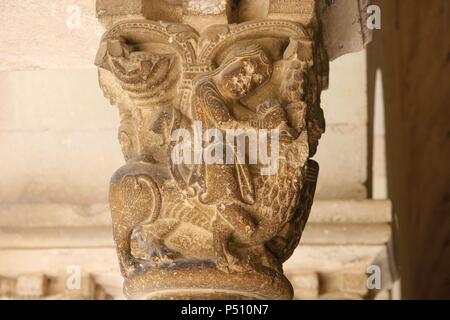 Art Romanesque. The Royal Benedictine Monastery of Sant Cugat. Built betwenn 9th and 14th centuries. Capital depicting Samson slaying the lion.  Cloister. Sant Cugat del Valles. Barcelona. Catalonia. Spain. Stock Photo