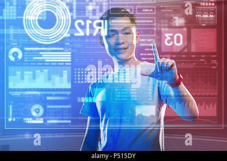 Cheerful young man touching the transparent screen and smiling happily Stock Photo