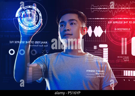 Attentive software developer using a security system and touching the screen Stock Photo