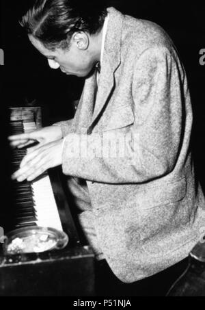 Jazz musician Horace Silver looking down at the keyboard while playing a piano, 1955. Stock Photo