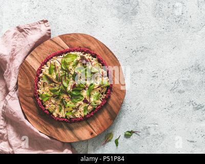 beetroot pizza crust with fresh swiss chard or mangold beetroot leaves.Ideas and recipes for healthy vegan snack.Egg-free pizza crust with chia seed and wholegrain brown rice flour.Copy space.Top view Stock Photo