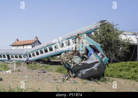 At least two people have been killed and 18 injured after a train crashed into a lorry and derailed outside the Italian city of Turin.  Rescuers were working through the night to look for passengers trapped under the wreckage of the train, which smashed into the big-rig lorry near the town of Caluso at 11.20 pm.  The Rfi regional railroad said the railway barrier had lowered properly before the train's approach but for reasons unknown the lorry smashed through the barrier and ended up on the tracks.  The crash, which occurred about 50 minutes into the journey out of Turin, derailed three train Stock Photo