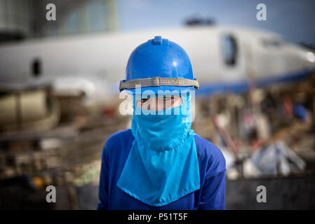 Woman hard hat, female builder. Thailand building site, female construction worker. Stock Photo