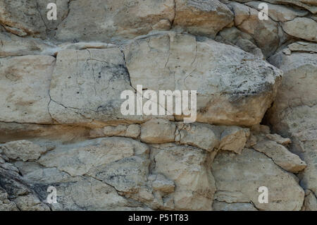 Background. The texture of the rock is made of light limestone, covered with cracks, consisting of large and small stones. Stock Photo