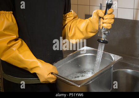 Cleaning of stainless steel containers in a large kitchen Stock Photo