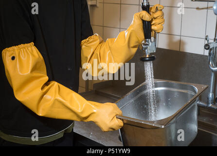 Cleaning of stainless steel containers in a large kitchen Stock Photo