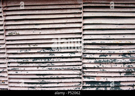 Brick wall with a rusty iron grille in it Stock Photo