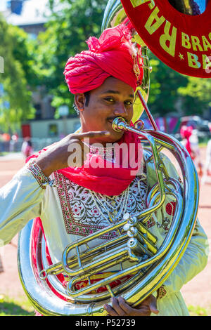 Glasgow, UK. 24th June, 2018. On a sunny summers day, thousands turned out to the annual Glasgow Mela held in Kelvingrove Park to enjoy a day of celebration of all aspects of Asian culture. There were many Asian bands and dance troops including the RAJASTAN HERITAGE BRASS BAND on their second appearance at the Mela and the GABHRU PANJAB DE Asian dance troop from Birmingham on their first appearance Credit: Findlay/Alamy Live News Stock Photo