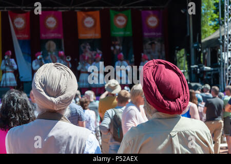 Glasgow, Scotland, UK. 24th June, 2018. Glasgow Mela, an annual multicultural music festival held in Kelvingrove Park. This year's performers included Miss Pooja, Akbar Ali, Black Star Steel Band, G Town Desi, Raj Brass Band, Thai Dance Academy, D & F Bros Grand Indian Circus and traditional bangra dancers Gabhru Panjab De. Credit: Skully/Alamy Live News Stock Photo