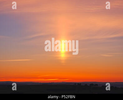 Brassington, Derbyshire, UK. 24th June, 2018. Weather UK: sun pillar solar column during an amazing sunset at Harborough Rocks near Brassington & the High Peak Trail, Derbyshire, Peak District National Park Credit: Doug Blane/Alamy Live News