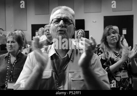 June 23, 2018 - Lakeland, Florida, United States -Attendees raise their hands in song and prayer at the Second Annual Convention of the International School of Exorcism Advanced Academy of Deliverance on June 23, 2018 at Ignited Church in Lakeland, Florida. The three day gathering, hosted by Pastor Bob Larson, the founder of the International School of Exorcism, drew approximately 70 exorcists, students, and others, and featured training sessions, guest speakers, as well as a number of exorcism rituals. (Paul Hennessy/Ģ����ý) Stock Photo
