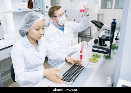 Scientists testing meat nutrition in laboratory Stock Photo