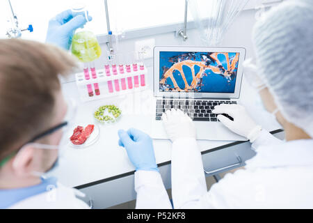 Microbiologists studying DNA of food samples Stock Photo