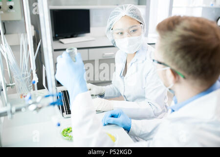 Scientists discussing food nutrition test results  Stock Photo