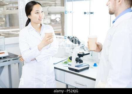 Scientists resting in laboratory with drinks Stock Photo