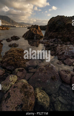 Punta del Hidalgo, Tenerife. Sun setting over Natural Pools in Punta del Hidalgo Stock Photo