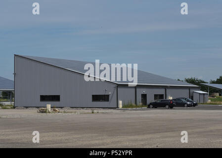 June 29, 2015 - Ungersheim, France: General view of the solar power plant of Ungersheim, whose solar panels are installed on the roof of warehouses.This small Alsacian village (population: 2000) is known as the greenest village in France because of its various environment-friendly initiatives: construction of a solar power plant, use of municipal agricultural land to promote local bio food, horse transport for school children, pesticide-free green spaces, eco-lodging, wood heating, etc. Ungersheim is part of the transition network, an international association promoting measures towards climat Stock Photo