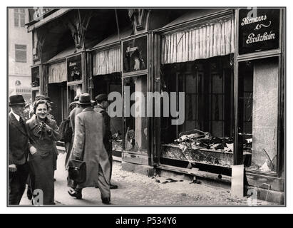 KRISTALLNACHT BERLIN JEWISH SHOP FRONT Shattered storefront of a Jewish-owned shop destroyed by Nazi NSDAP sympathisers during Kristallnacht (the 'Night of Broken Glass'). Berlin, Germany, November 10, 1938. Passing onlookers apparently smiling in appreciation...Berlin Germany Stock Photo